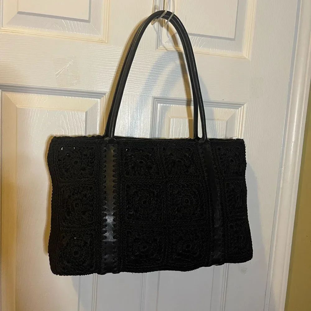 The SAK Elegant Black Crochet shoulder bag synthetic black straps.